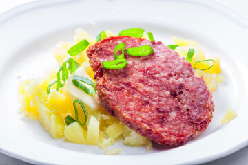 slice of meatloaf with potatoes and spring  onion