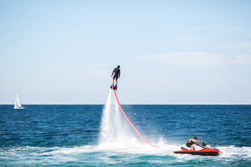 Silhouette of a fly board rider at sea