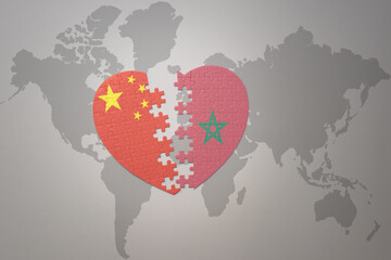 puzzle heart with the national flag of china and morocco on a world map background. Concept.