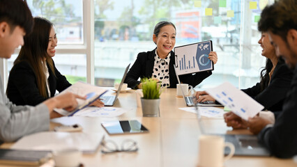 Professional Asian senior businesswoman having a meeting with a new business team