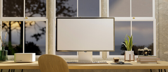 Modern home workstation interior with pc computer and decor on table against the window.