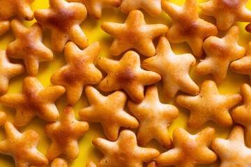 close up view of tasty cookies in shape of stars on yellow