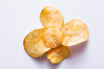 top view of delicious, fried and salty potato chips on white
