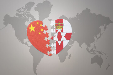 puzzle heart with the national flag of china and northern ireland on a world map background. Concept.