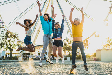 Group of young people jumping on the sand, freinds having fun in a beach party, freedom and joyful summer image, london people travelling