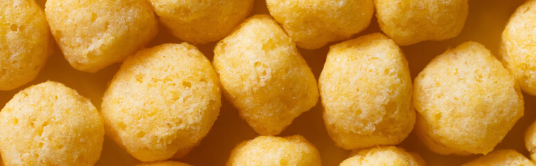 top view of puffed, delicious and salty cheese pops, banner