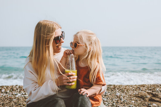 Family Vacations Child Drinking Smoothie With Mother On Beach Travel Outdoor Healthy Lifestyle Mom And Daughter Walking Together Summer Trip