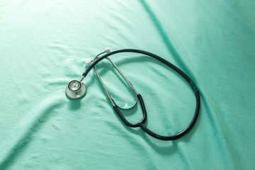 Overhead view of a stethoscope. A stethoscope on a bed at hospital