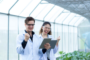 Scientist using Tablet. Scientist work at Vegetable Garden Lab site	
