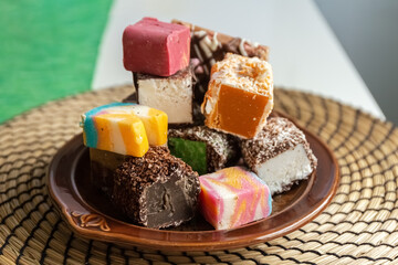 Multi-colored sweets on a plate. Delicious sweets. Photo