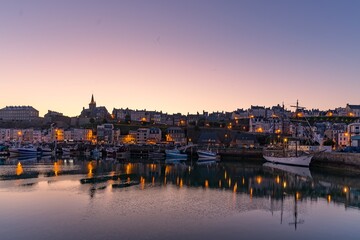 The harbor roadstead of the city of Granville in Europe, France, Normandy, Manche, in spring, at night - obrazy, fototapety, plakaty