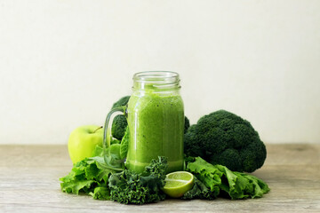 Diet green smoothie in a glass jar of fruits and vegetables: apple, broccoli, lime