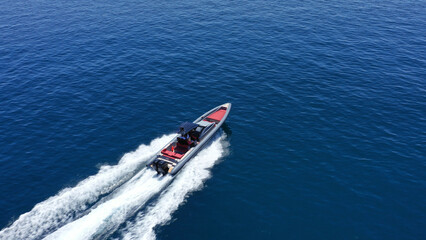 Aerial drone photo of inflatable rigid power boat cruising in high speed in Aegean deep blue sea...