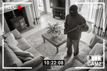 CCTV surveillance security camera of burglar breaking into home through back door window with crowbar - 506394638