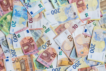 Lots of different Euro banknotes shown as a mess