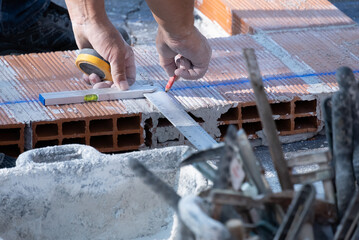 Various masonry and brickwork tools being used on a construction site
