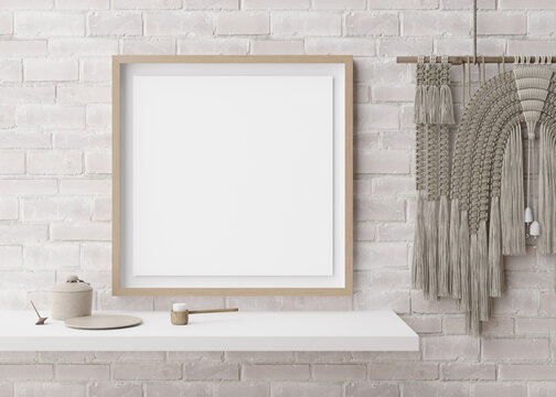 Empty square picture frame on white brick wall in modern room. Mock up interior in contemporary, boho style. Free, copy space for picture. Macrame. 3D rendering.