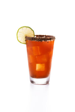 Homemade michelada cocktail with beer, lime juice,hot sauce,salted Rim and tomato juice isolated on white background