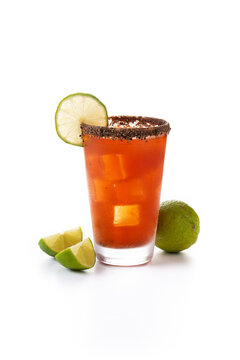 Homemade michelada cocktail with beer, lime juice,hot sauce,salted Rim and tomato juice isolated on white background