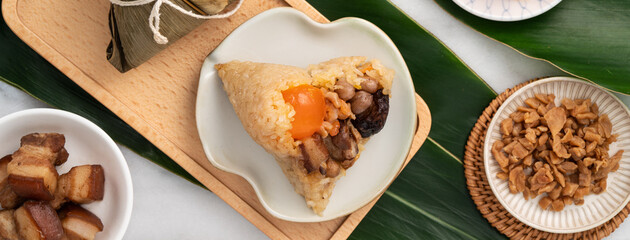 Zongzi. Rice dumpling for Dragon Boat Festival on bright marble table background with ingredient.