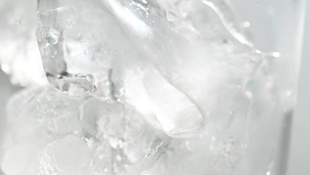 Pouring melon soda juice into glass with ice