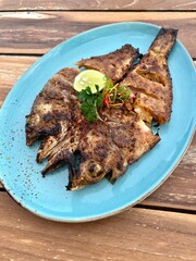 grilled fish with vegetables in the plate