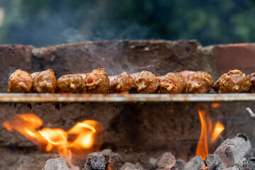 BBQ season is on, grilled meat on the grill, flames and charcoal