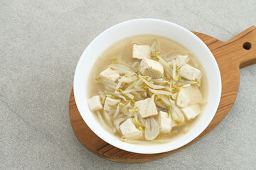 Ca Tauge or Tumis Tauge,  Indonesian stir fried bean sprouts mixed with tofu, served in white bowl. Selected focus.
