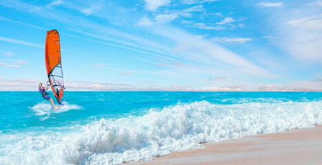 Beautiful cloudy sky with Windsurfer Surfing The Wind On Waves - Panoramic seaview with picturesque beach at sunset - Bali, Indonesia © muratart