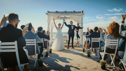 Beautiful Bride and Groom During an Outdoors Wedding Ceremony on an Ocean Beach. Perfect Venue for...