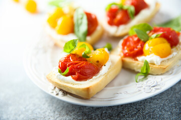 Tomato crostini with cream cheese and fresh basil