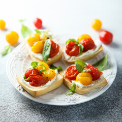 Tomato crostini with cream cheese and fresh basil