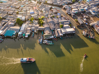 Fototapeta na wymiar Aerial view of fishing boat speeding through fisherman village at Pak Nam Sichon, the estuary area in Chumphon province, Thailand.