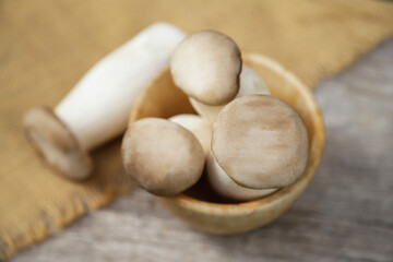 brown mushroom on wooden table for being ingredients in cooking in kitchen. selective focus.