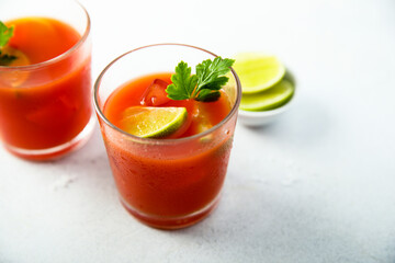 Homemade tomato cocktail with fresh lime