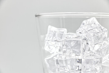 Ice in glass closeup on a white background.