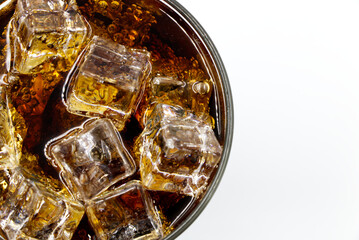 Cola glass with crushed on a white background cola ice in glass and there is water droplets around. cool black fresh drink.