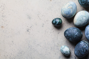 Easter eggs painted in trendy denim blue, gray background.
