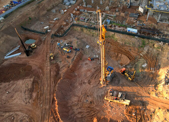 Deep foundation machine. Drilling rig and Pile driver at construction site. Pile driven into ground...