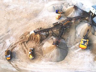 Sand Making Plant and Belt conveyor in mining quarry. Mining excavator loading sand in haul truck...