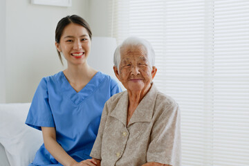Portrait of young Asian woman, nurse, caregiver, carer of nursing home and senior Asian woman...
