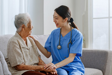 Young Asian woman nurse, caregiver, carer of nursing home cheer up a senior Asian woman at home