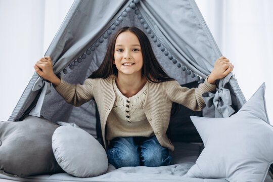 Cute little girl sitting in vigvam tent