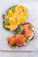 Scrambled eggs with smoked salmon, cream cheese and avocado on toast , Breakfast food