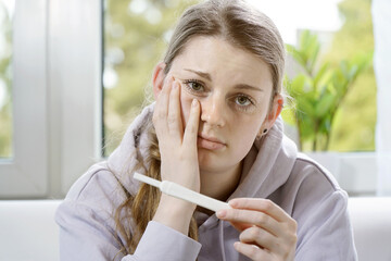 Young woman is unhappy about her pregnancy test