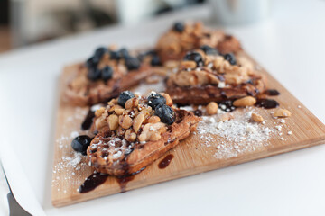 waffles with peanuts and chocolate and whipped cream