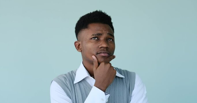 Confused man coming up with a good idea over blue background