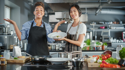 TV Cooking Show Kitchen with Two Master Chefs. Asian and Black Female Hosts Talk. Professionals...