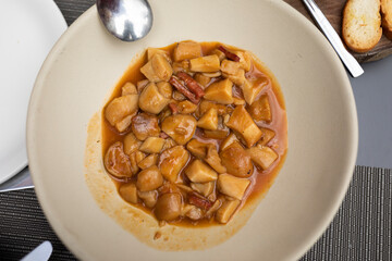 Example of a typical tapa of the local gastronomy, a delicious mushroom stew Biscayan style with ham and sauce