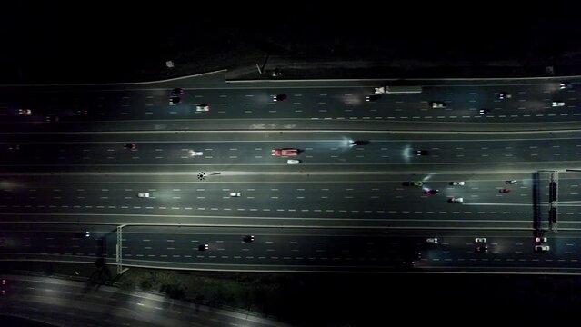 Cars rushing through highway traffic at night, flying view from above, Highway 401 Canada